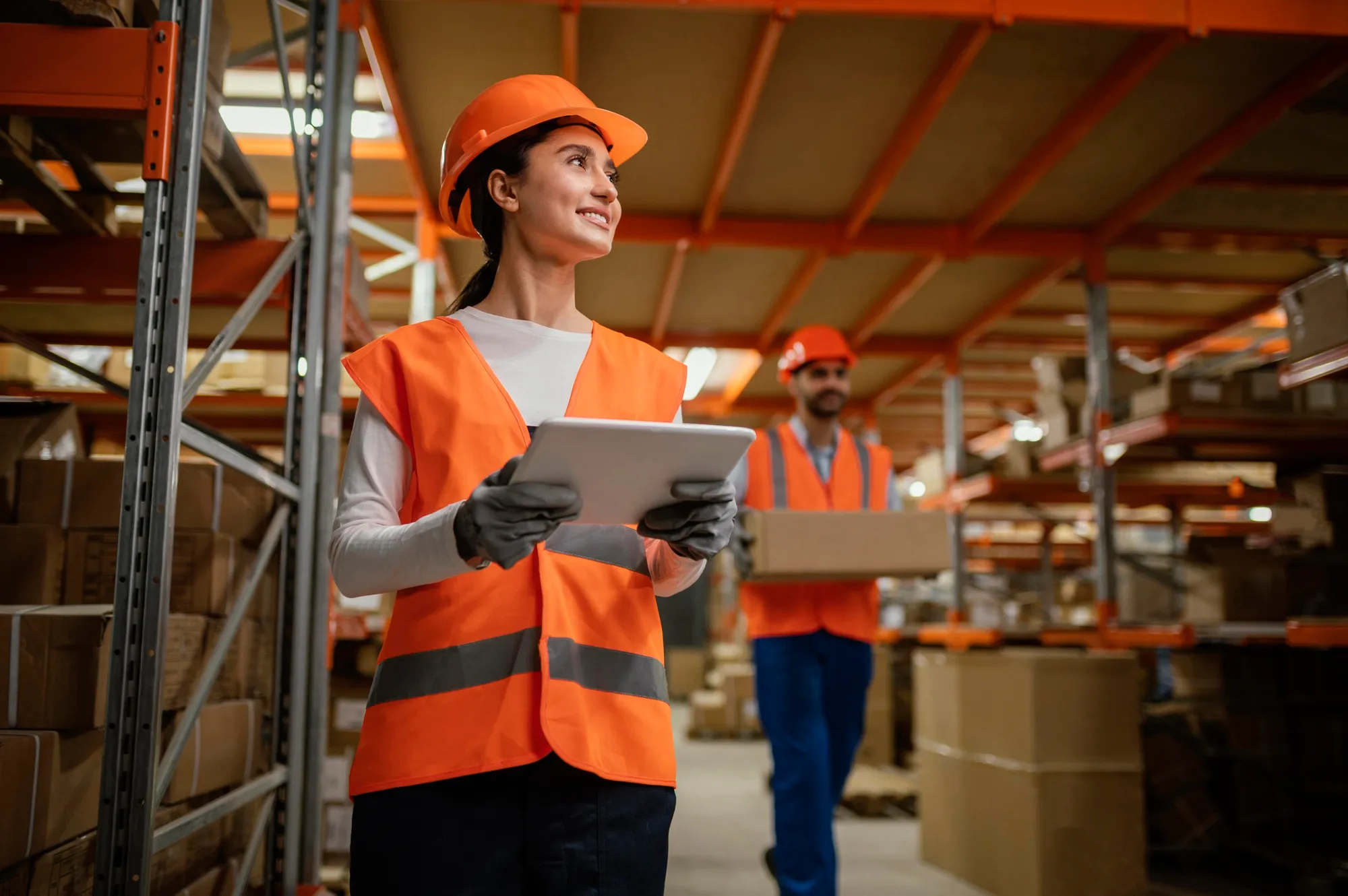 Correspondent in a safety vest inside a warehouse